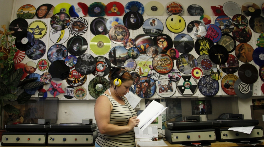 Employee Petra Kottova checks the sound quality of a pressed vinyl record at the GZ Media factory in Lodenice August 1, 2013 Employee Petra Kottova checks the sound quality of a pressed vinyl record at the GZ Media factory in Lodenice August 1, 2013